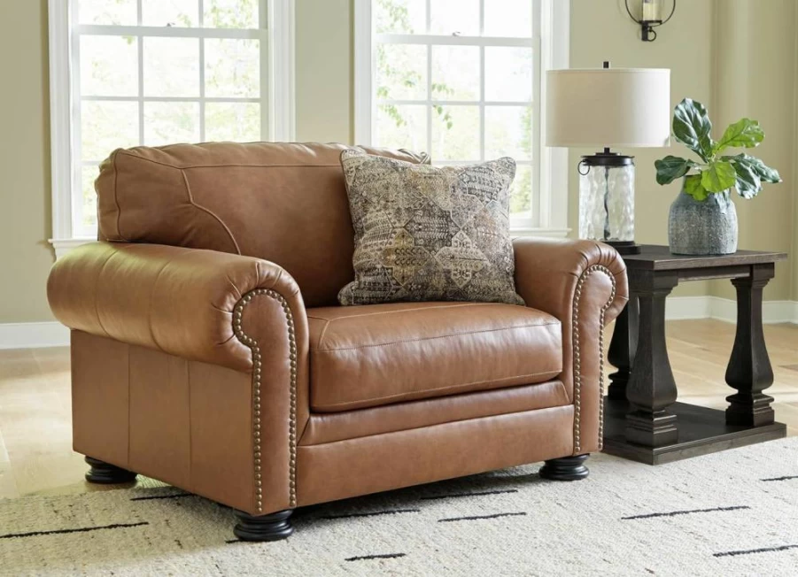 Signature Design by Ashley Carianna Oversized Leather Match Chair with Nailhead Trim & Accent Pillow, Dark Brown Contemporary Upholstered Seating