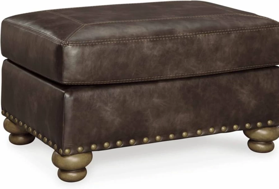 Signature Design by Ashley Nicorvo Brown Faux Leather Ottoman with Gold Nailhead Trim - Traditional Style Footstool Bench