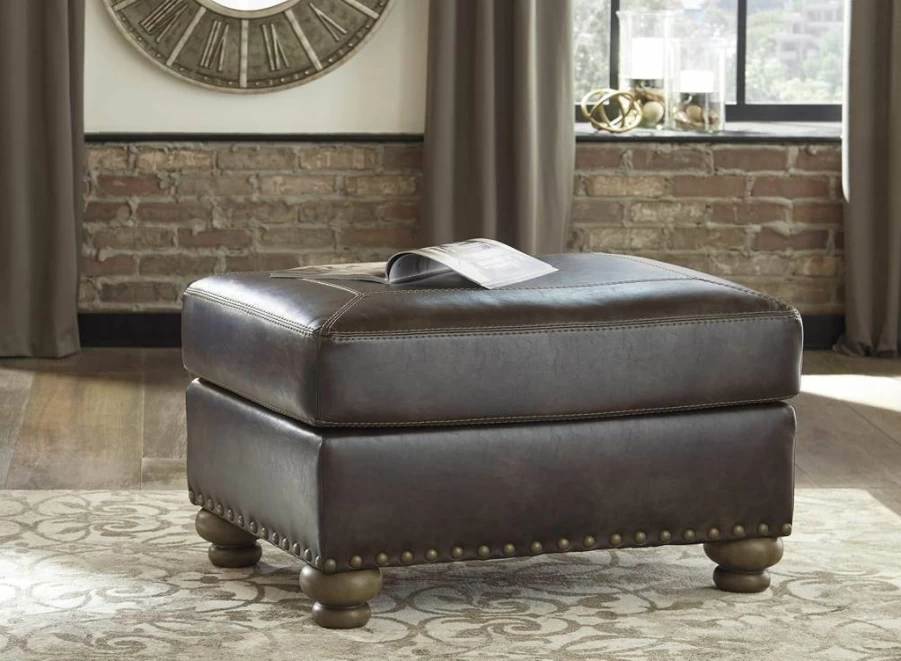 Signature Design by Ashley Nicorvo Brown Faux Leather Ottoman with Gold Nailhead Trim - Traditional Style Footstool Bench