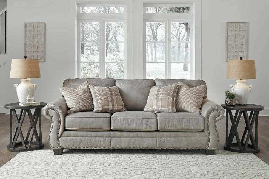 Signature Design by Ashley Olsberg Gray Faux Leather Sofa with Nailhead Trim & 4 Decorative Pillows